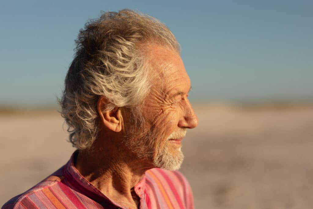 Old man relaxing at the beach
