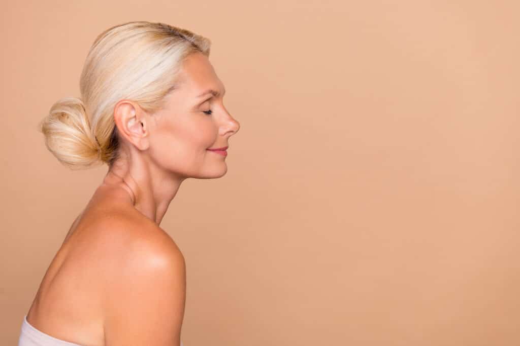 Photo of pretty charming nude lady wear nothing closed eyes empty space isolated beige color background